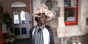 Amazing hat made from recycled train tickets being modelled outside Shrinking Violet Bespoke Floristry at Great Malvern Station